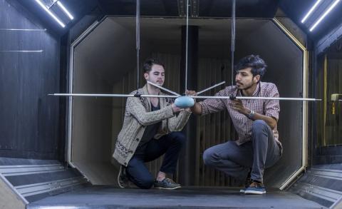Two researchers experimenting in a wind tunnel