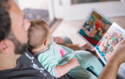 Father reading a book to his baby