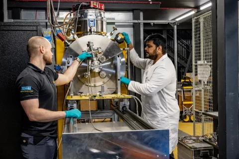 Researchers working with testing equipment