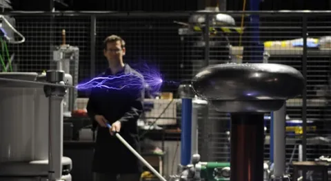 A man doing an experiment on electricity power in a lab