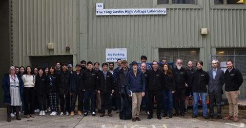Group of researchers and students in front of the Tony Davies High Voltage laboratory