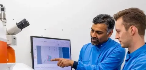 Professor Sumeet Mahajan and student at a computer
