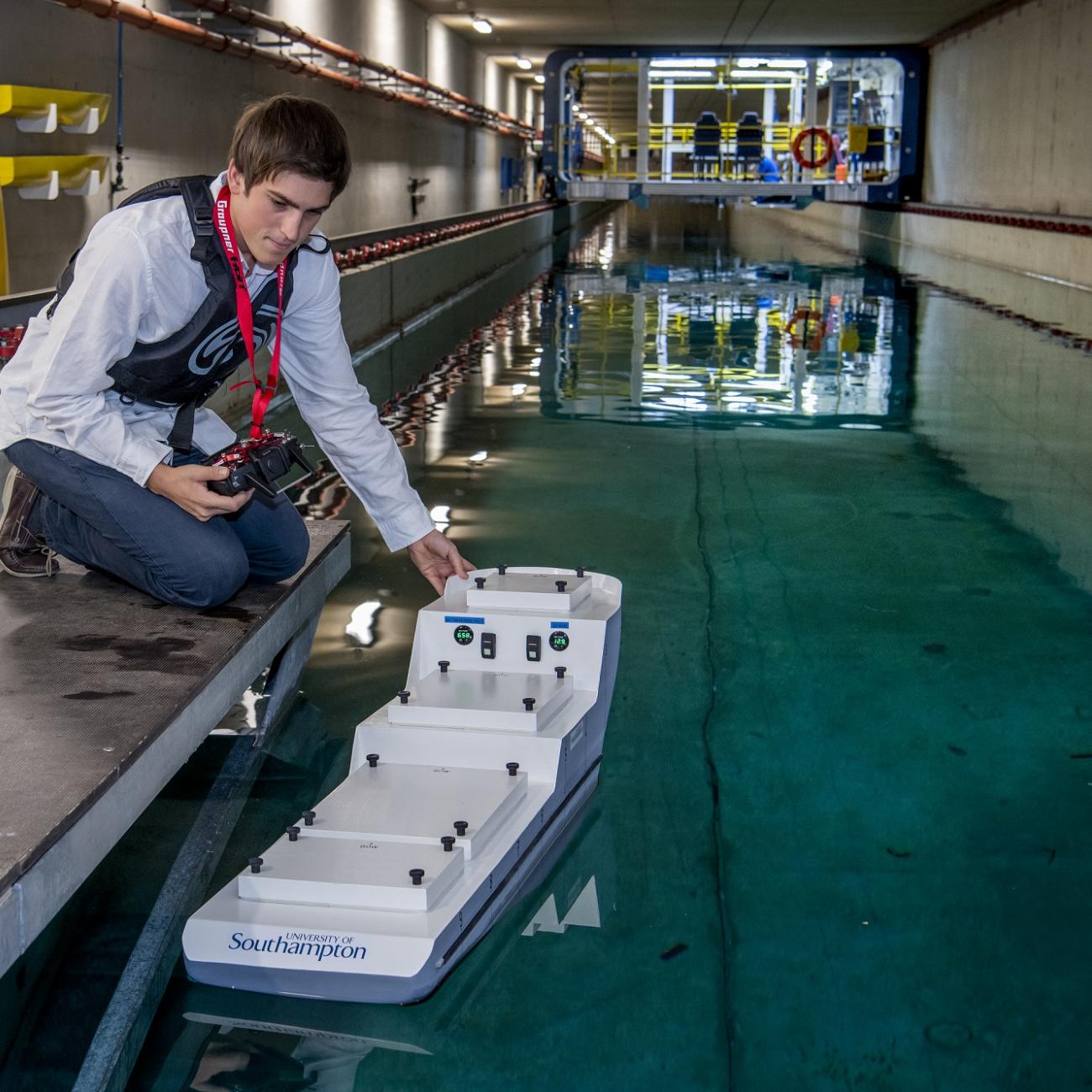 Ship science student Umberto Varbaro tests a model ship in the towing tank