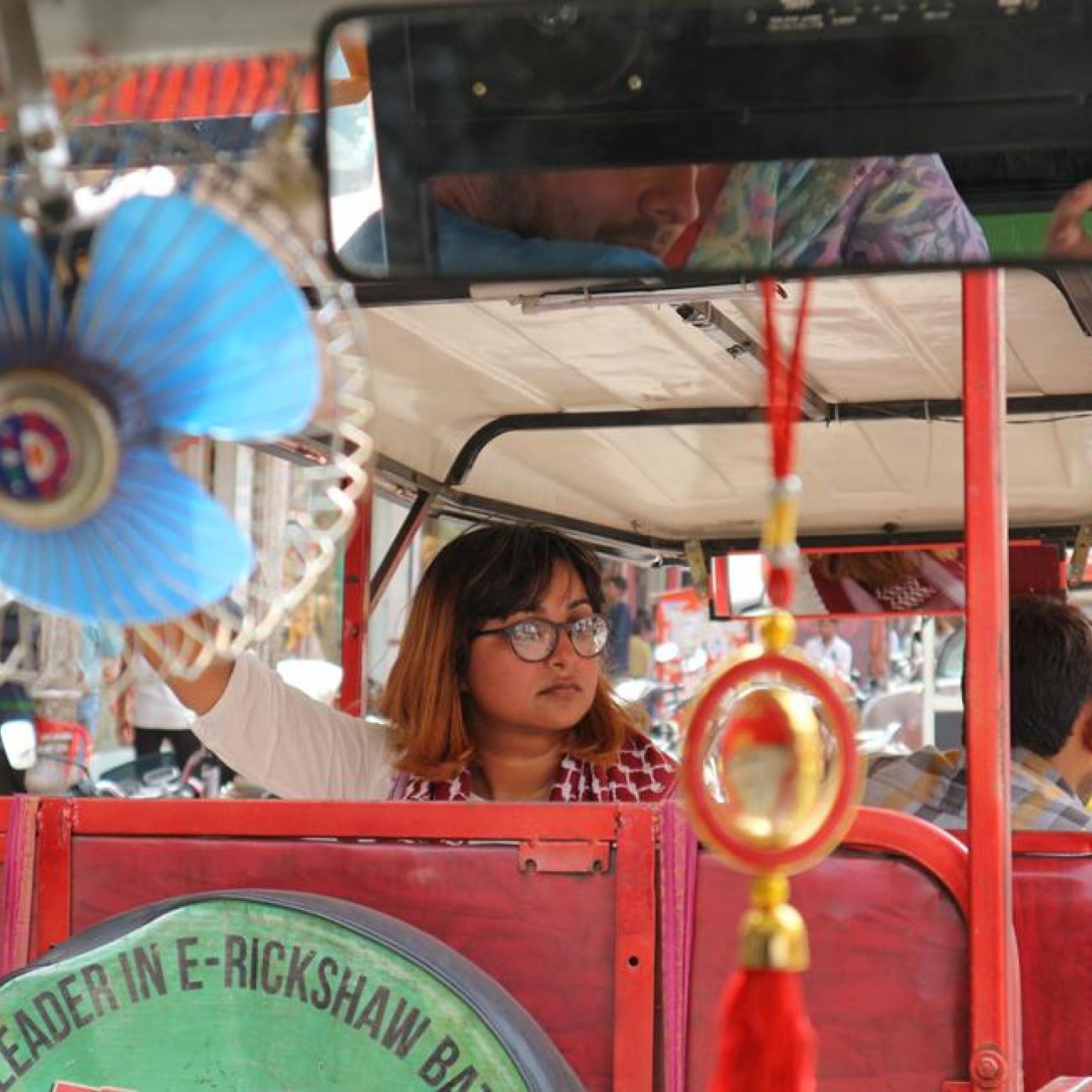 A woman travelling in a Tuk-tuk