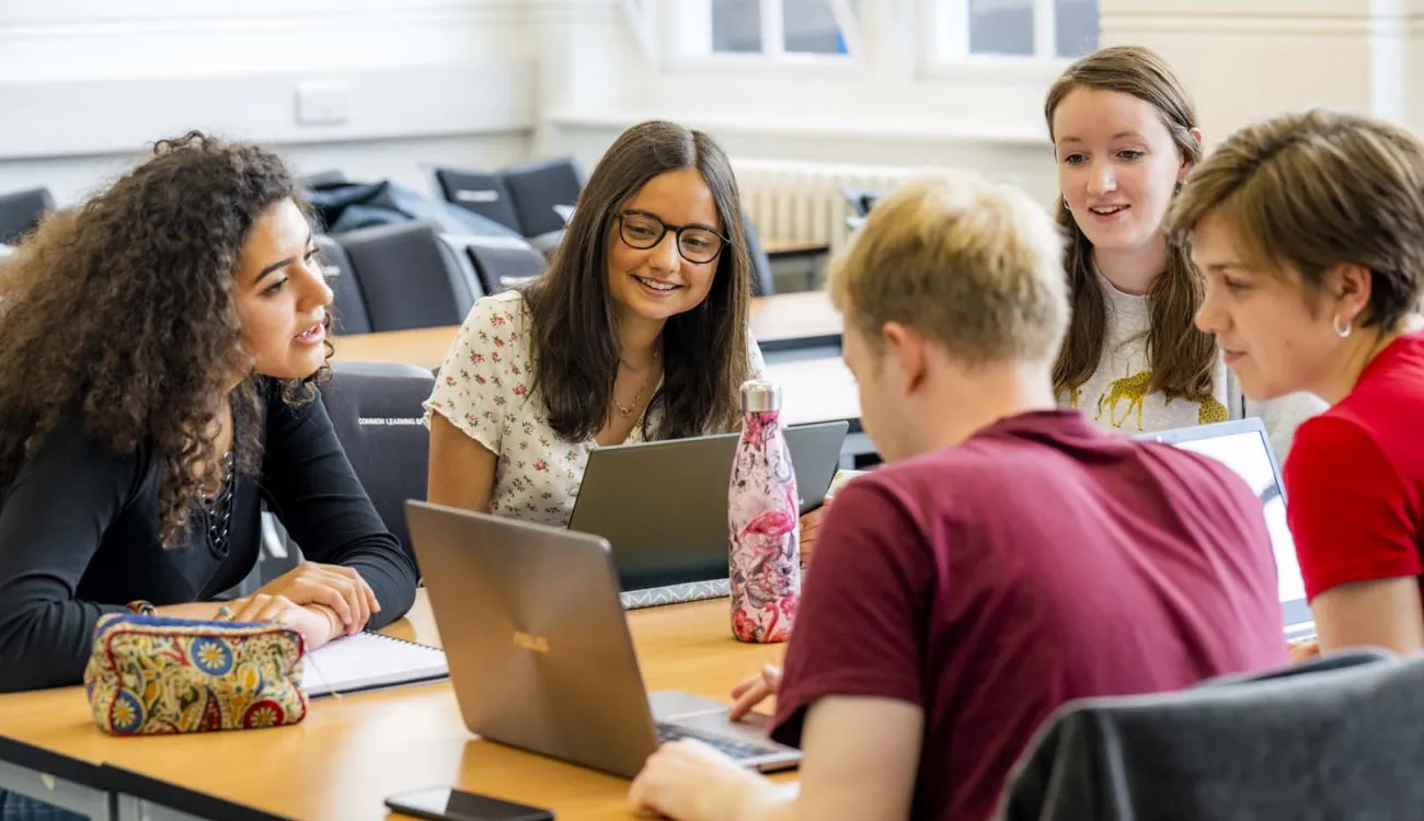 Modern Language students discussing laptop contents