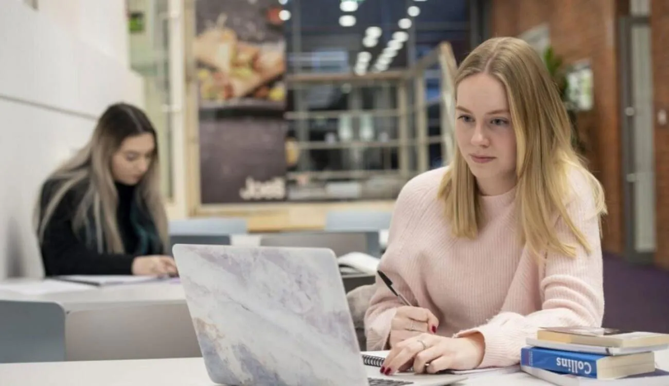 Student studying with laptop in study area