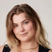 Head and shoulders portrait image of Nicole Karkut, BA Fashion Marketing with Management student smiling at the camera.