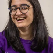 Head and shoulders portrait image of Rhianna Saglani, MA History student smiling and looking at the camera.