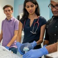 four undergraduate medical students with a patient