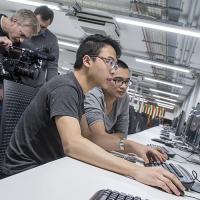 Two students working at a computer in the David Barron computing lab.