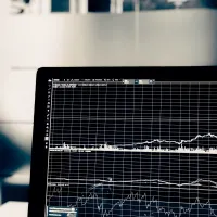 A laptop displaying a graph.