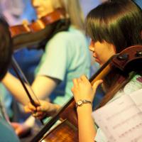 A student playing cello as part of the Southampton University Symphony Orchestra.