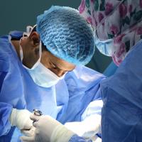 Image of two surgeons performing surgery. 