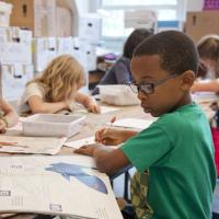 young children drawing and writing and school