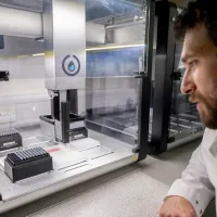 Scientist looking at lab equipment